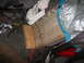 1995 Ford Bronco - The interior of a vehicle is cluttered with trash, a wooden block, and exposed wiring, obscuring any identifying features.