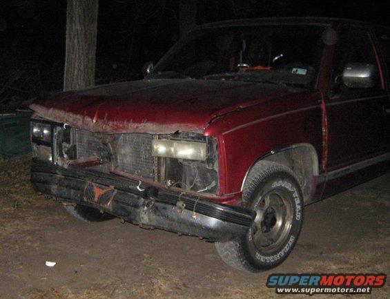 Red pickup truck front view, damaged bumper and grille