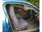 Blue car interior with fabric seats and dashboard visible through open door