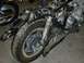 1980 Honda CB750 - The motorcycle is partially disassembled, showing its frame, engine, and rear wheel assembly.
