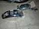 1980 Honda CB750 - Two motorcycle fenders, one chrome and one black, lie on a concrete surface, possibly awaiting installation or repair.