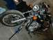 1980 Honda CB750 - A motorcycle is shown with its front wheel and engine components visible, alongside a blue jack.