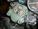 1980 Honda CB750 - Close-up of a green motorcycle's electrical housing, showing exposed wiring and a tachometer dial.