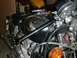 1980 Honda CB750 - A close-up view of a motorcycle's engine and fuel tank, with another motorcycle in the background.