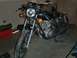 1980 Honda CB750 - A motorcycle is parked indoors, possibly in a garage, with tools and storage items visible in the background.