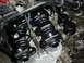 1980 Honda CB750 - Close-up view of motorcycle engine components, including carburetors and air filters, during a rebuild.