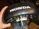 1980 Honda CB750 - A black Honda motorcycle seat is shown from underneath, with mounting hardware visible.