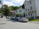 2003 Mazda 6 - A group of Mazda 6 sedans are parked on a street in front of houses.