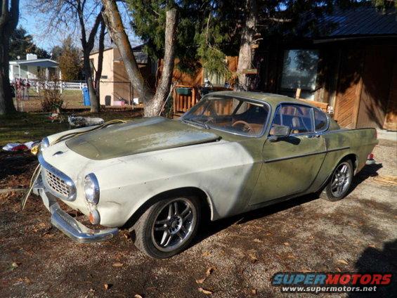 Volvo P1800 coupe, primer on front end, green body, parked outside