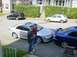 2003 Mazda 6 - Two men stand near a silver 2003 Mazda 6 sedan parked next to a blue Mazda 6.