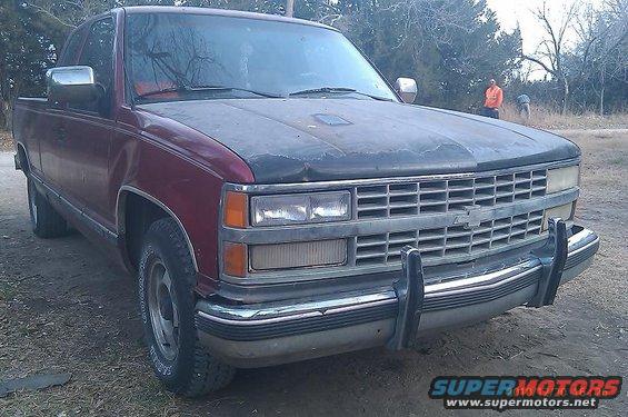 Maroon pickup truck with a dark hood, parked outdoors