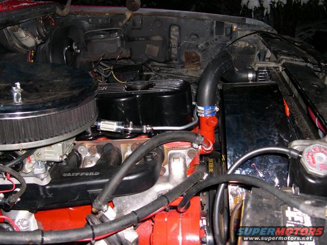 300-underhood_view2.jpg A side shot that shows the EFI style exhaust manifolds, brake line wrapped around to supply fuel, and the tiny alternator that later got replaced by a 3G version.