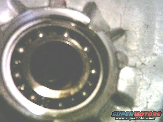Close-up of a wheel bearing assembly with visible ball bearings and metal housing