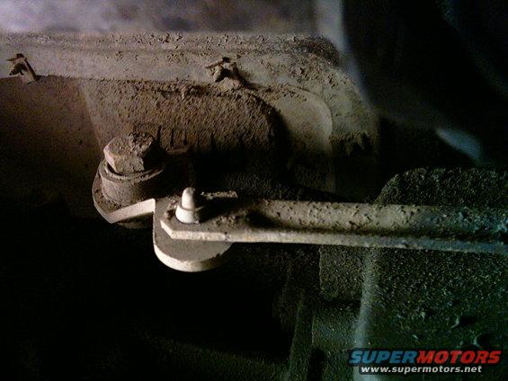 Close-up of a transfer case linkage with bolts and a lever