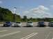 2003 Mazda 6 - A line of Mazda 6 sedans are parked in a lot under a bright, cloudy sky.