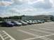 2003 Mazda 6 - A line of sedans, including a blue 2003 Mazda 6, are parked in a lot in front of a Filene's department store.