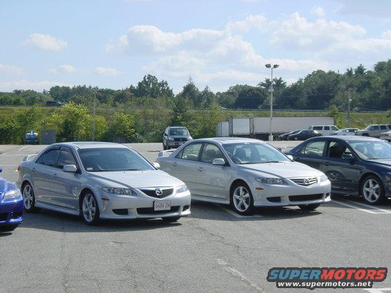 Two silver 2003 Mazda 6 sedans parked side-by-side, with a dark blue Mazda 6 partially visible on the left