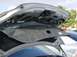 2003 Mazda 6 - The interior of a car's trunk is visible, with insulation and mechanical components exposed.