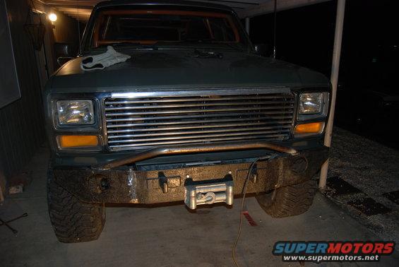 Dark green 1982 Ford Bronco front view with chrome grille and winch
