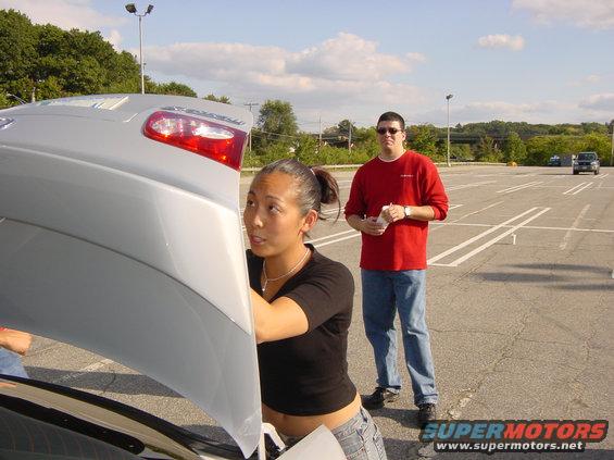 Silver 2003 Mazda 6 rear view with open trunk