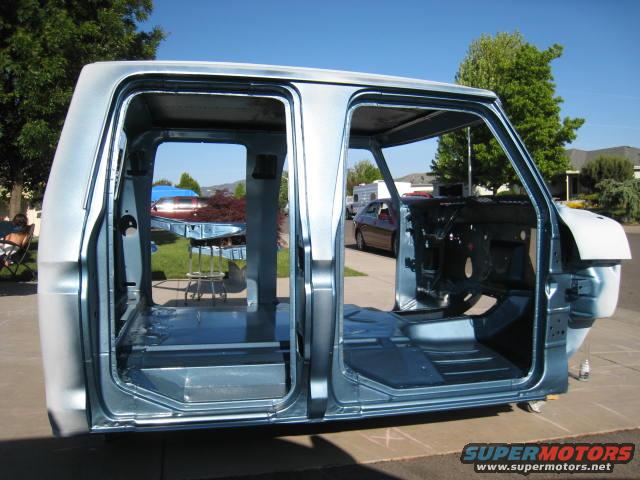 Cab of a 1973 Ford F-Series truck, stripped down for restoration, sitting outside