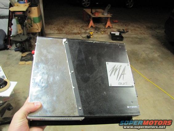 Hand holding a car amplifier with MA audio logo and model number M16891