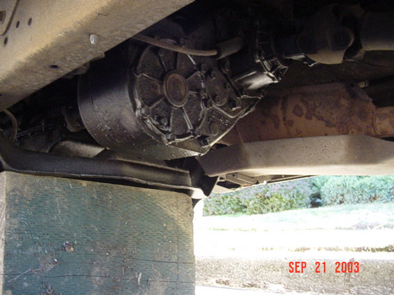 Transfer case underside of vehicle, supported by wooden blocks