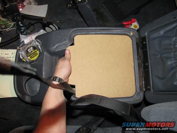 Center console with cardboard insert and tape measure