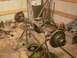 1995 Ford Bronco - A disassembled vehicle axle assembly is shown on stands, surrounded by various tools and spare parts in a workshop.