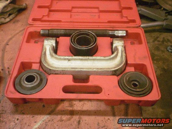 Ball joint press tool kit in red plastic case. Includes C-clamp, screw, and cups