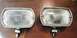 1968 Mercury Cougar - Close-up of two vintage fog lights, possibly for an older vehicle, resting on a table.
