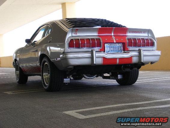 Rear view of a silver and red 1977 Ford Mustang II Cobra II with a Nevada license plate that reads '77 COBRA'