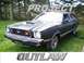 1978 Ford Mustang II - This 1978 Ford Mustang II coupe, seen from a three-quarter front view, is parked on a grassy area with trees in the background.