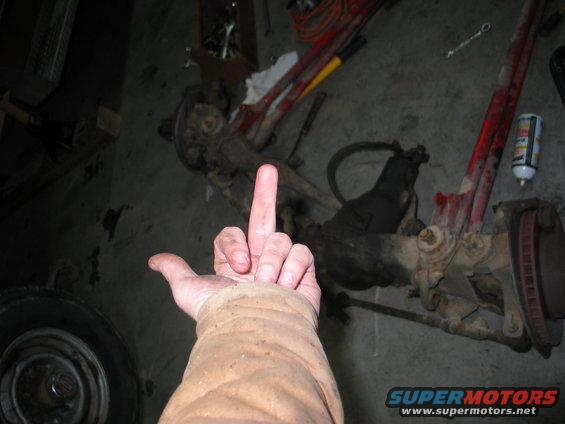 Front axle assembly with a hand giving the middle finger