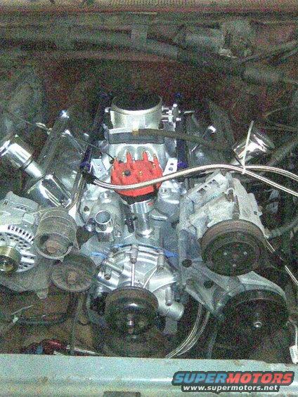 Engine bay with V8 engine, chrome accents, and red distributor cap