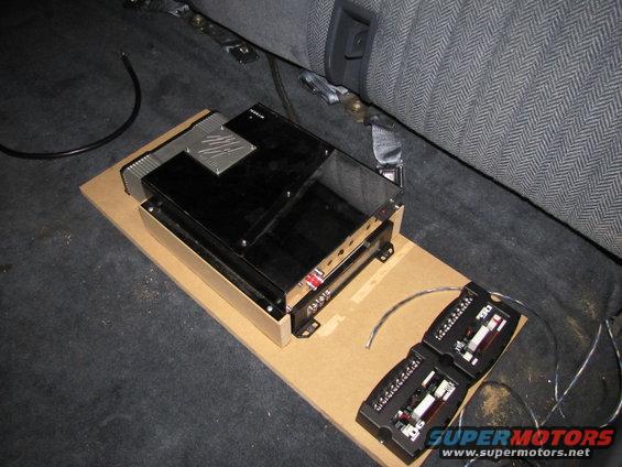 Car interior with audio amplifiers and wiring on a wooden board