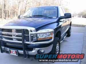 Blue 2006 Dodge 2500 pickup truck with a chrome grille guard parked on a concrete pad