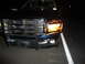 2006 Dodge 2500 - Front view of a dark blue pickup truck a chrome grille and brush guard, likely a 2006 Dodge 2500.