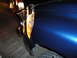 2006 Dodge 2500 - The front corner of a dark blue pickup truck is shown, a chrome bull bar and amber turn signal light.