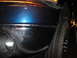 2006 Dodge 2500 - Close-up view of the front corner of a blue truck, showing the headlight and chrome bumper.