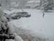 1972 Ford Ranchero - Cars are stuck in deep snow on a street with houses in the background.