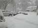 1972 Ford Ranchero - Snowfall blankets parked cars and the surrounding neighborhood, creating a winter scene.
