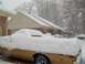 1972 Ford Ranchero - A vehicle is completely covered in snow during a winter storm.