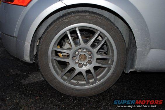 Silver 2001 Audi TT rear wheel and fender, showing a multi-spoke alloy wheel and part of the taillight