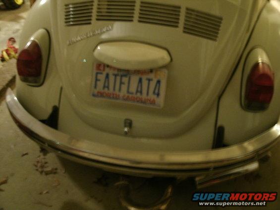 Cream-colored Volkswagen Beetle rear with a North Carolina license plate reading FATFLAT4