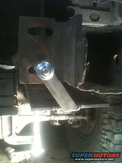 Custom trailer hitch receiver bracket with a bolt and metal strap