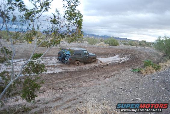 1982 Ford Bronco stuck in mud on a trail