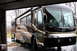 2003 Ford F-350 - A motorhome is parked inside a garage with the door open.