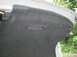 2003 Mazda 6 - The interior of a vehicle's trunk is visible, gray carpeting and a recessed handle.