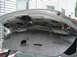 2003 Mazda 6 - The interior of a car's trunk is visible with wiring and insulation removed.